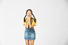 Isolate Young Tan Asian Woman Wearing Yellow T-shirt, Jeans Dungarees And Expressive Facial On White Background