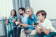 © VadimGuzhva - Happy Family Playing on Console Together at Home.