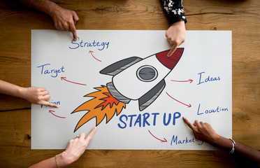 Wall Mural - Fingers pointing at a startup plan