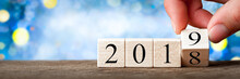 Hand Changing Date From 2018 To 2019 On Wooden Cube Calendar / New Year's Concept