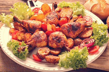 Vintage baked crispy chicken drumstick on white plate, close up view