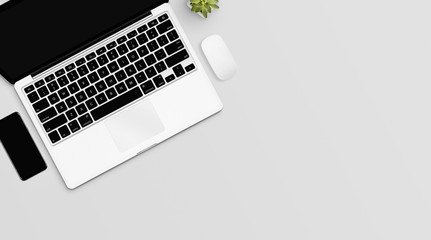 top view of white office desk table with laptop, phone, mouse and plant. flat lay, with empty space