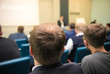 © KONSTANTIN SHISHKIN - People sitting rear at the business conference. Back view