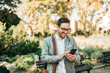 © bnenin - Happy elegant man using smartphone outdoors.