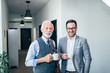 © bnenin - Senior businessman on a coffee break with younger colleague.