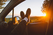 © ADDICTIVE STOCK - Crop legs in car during sunset