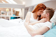 © NDABCREATIVITY - Romantic couple in love lying on bed