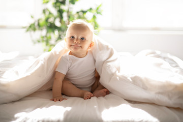 Poster - Cute baby girl on blanket white sheet at home