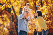 © Mediteraneo - Multl generation family in autumn park having fun