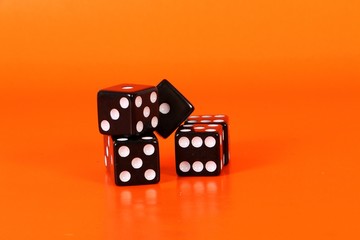 a heap of black dices are lying in the orange studio