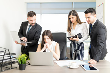 Wall Mural - Serious Team Leader And Executives Working At Desk