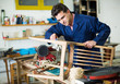 © JackF - Man carpenter in furniture repair workshop