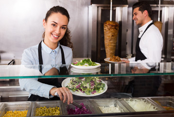 Portrait of two positive workers with kebab