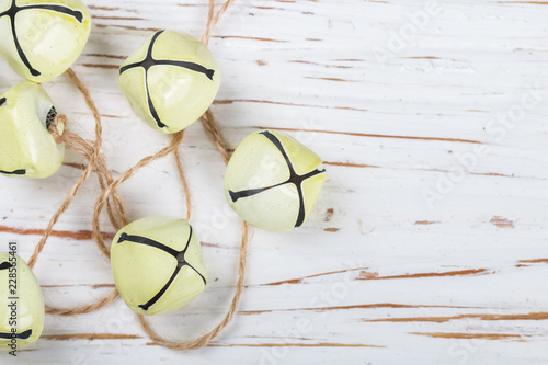 Christmas Decoration Yellow Jingle Bells On The Old White Table