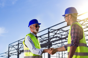 engineers shaking hands on construction site