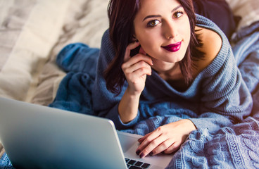 Wall Mural - Portrait of a young caucasian woman with notebook working at home