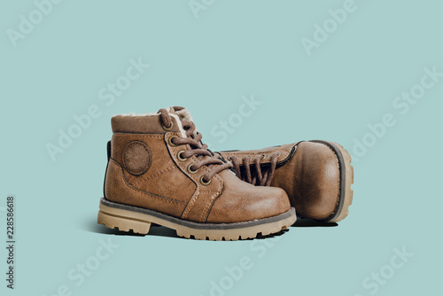 Fotografie, Obraz A pair of leather, children's shoes on a blue pastel background
