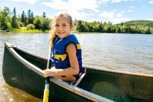 Happy Kid Enjoying Canoe Ride On Beautiful River