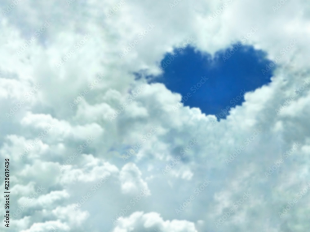 Blur image of blue heart shaped in many white clouds with blue sky for ...