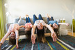© Louis-Paul Photo - mother and daughters on sofa at home upside down fun on sofa