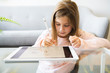 © Louis-Paul Photo - kid in living room at home and using digital tablet to draw