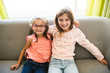 © Louis-Paul Photo - Two sisters girls sit on the sofa at home