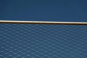 Metal fence against sky