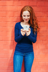 Wall Mural - Content woman looking down at smart phone