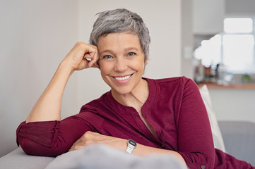 Wall Mural - Happy senior woman on couch