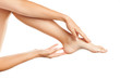 © vladimirfloyd - Young woman applying cream on her legs on white background