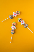 Halloween Candies Arranged In An Alternating Pattern On An Colored Background