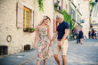 Outdoor lifestyle portrait of young couple in love in old town