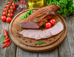 Traditional smoked meat on wooden table. Culinary meat eating.