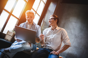 Two business colleagues sitting at a table, having a meeting.