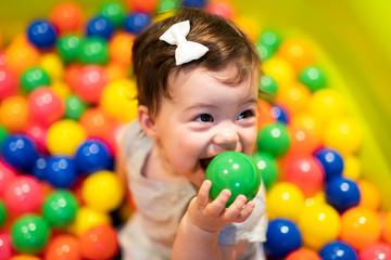 Portrait of a adorable infant on colorful balls