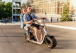 © Igor Kardasov - Lovely young couple driving electric bike. Modern city transportation