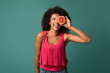 © Prostock-studio - Happy african-american woman holding half of grapefruit