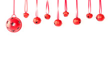 Jingle Bells With Ribbon Hanging In Front Of White Background