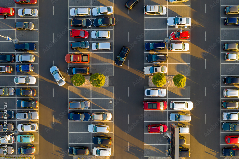 Top down view from drone on mall parking with many cars. - obrazy, fototapety, plakaty 