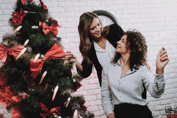 Wall Mural - Happy Workers Decorating Christmas Tree in Office.