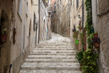 Fototapeta Na drzwi - Uphill alley with stairs  to the Medieval center of Caiazzo in the region of Campania, Italy.