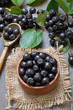 Black chokeberry in wooden bowl