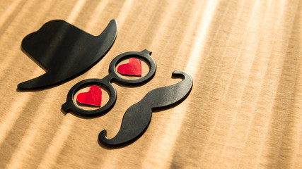 happy father's day background or card. sign of black hat, mustache and pipe with two red heart - eye