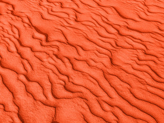Wall Mural - texture of red sand waves on the beach or in the desert. the ripples of the sand is diagonal.