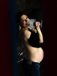 © Nikita Vasilchenko - Stylish pregnant woman changes clothes