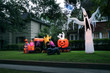 © Irina K. - The house is decorated for Halloween: Inflatable train with the dead, big pumpkin, black cat huge and small ghost. Night, Houston, Texas, United States