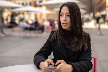 Wall Mural - Young woman in city using cell phone using cell phone