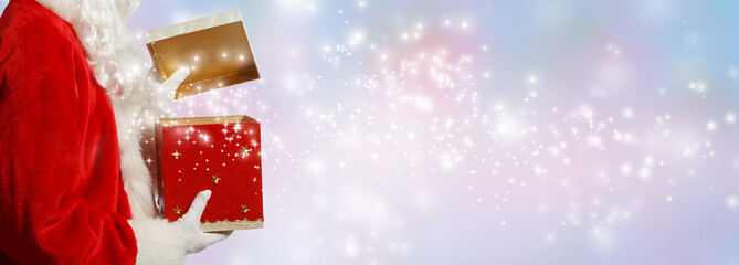 Wall Mural - santa opening a gift box on a shiny light background