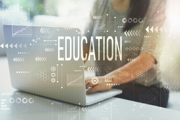Education with woman using her laptop in her home office