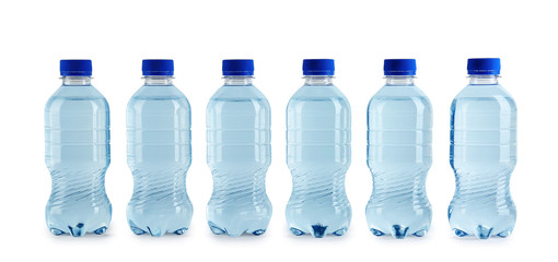 Collection of plastic bottles with water on white background